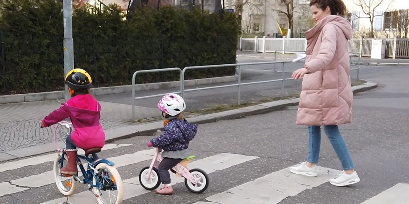 Women and two children crossing a road