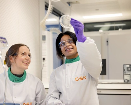 two microbiologists looking at an agar plate