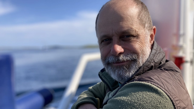 Patient standing on balcony, looking at camera