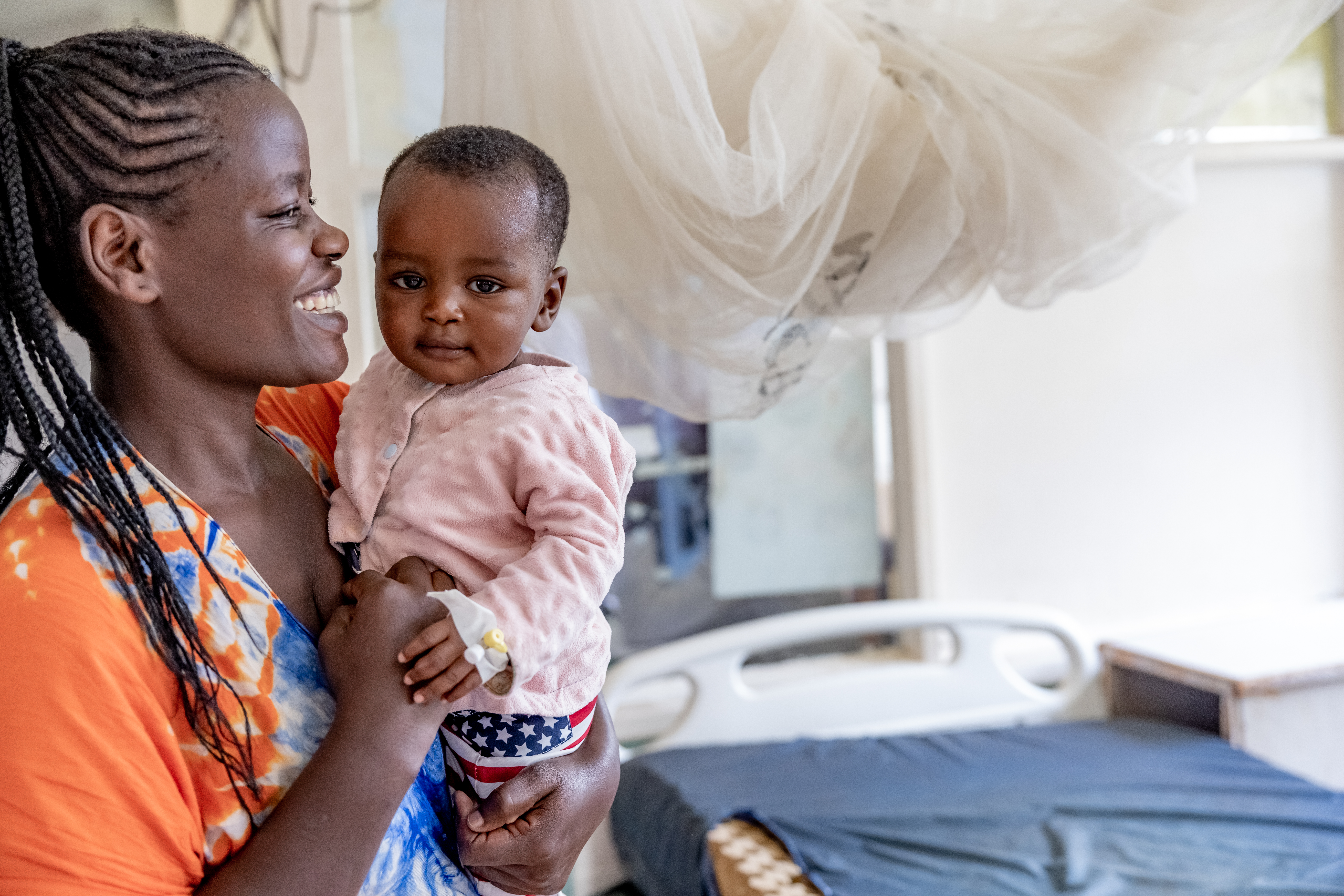 Mother holding her baby smiling