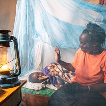 Mother and child using mosquito net in Kenya