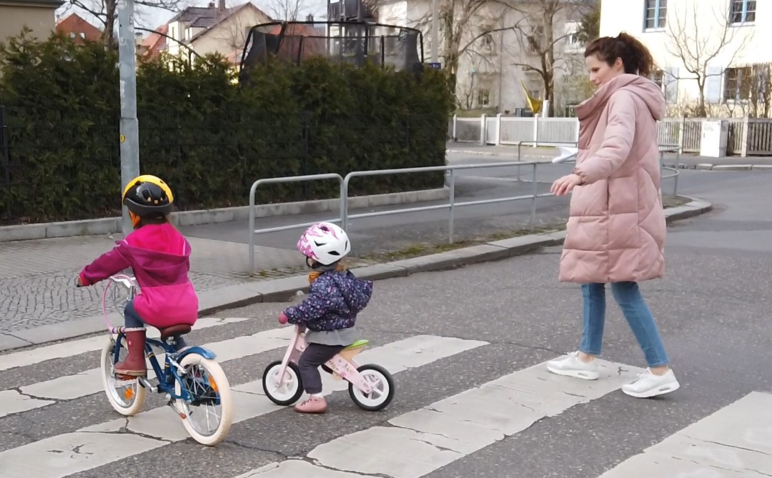 Women and two children crossing a road