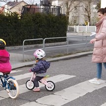 Women and two children crossing a road
