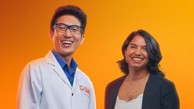 Male scientist and female dressed smartly smiling in a studio