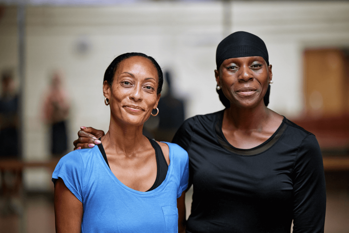 Two patients smiling with their arms round each other