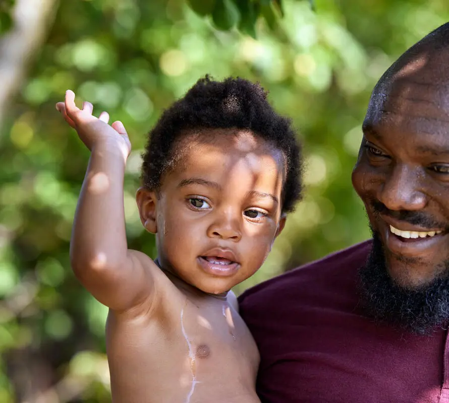 Father holding his son smiling