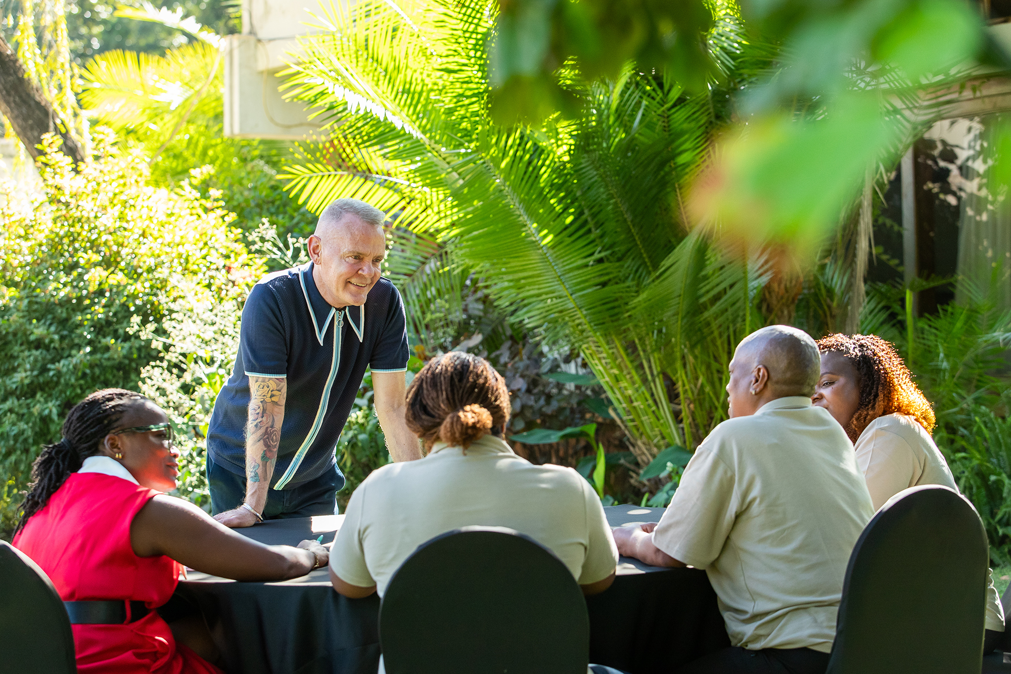 Shaun Mellors speaking to a group of people around a table