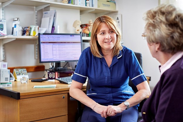Jacky Mellis, Research nurse talking to a patient in a surgery 