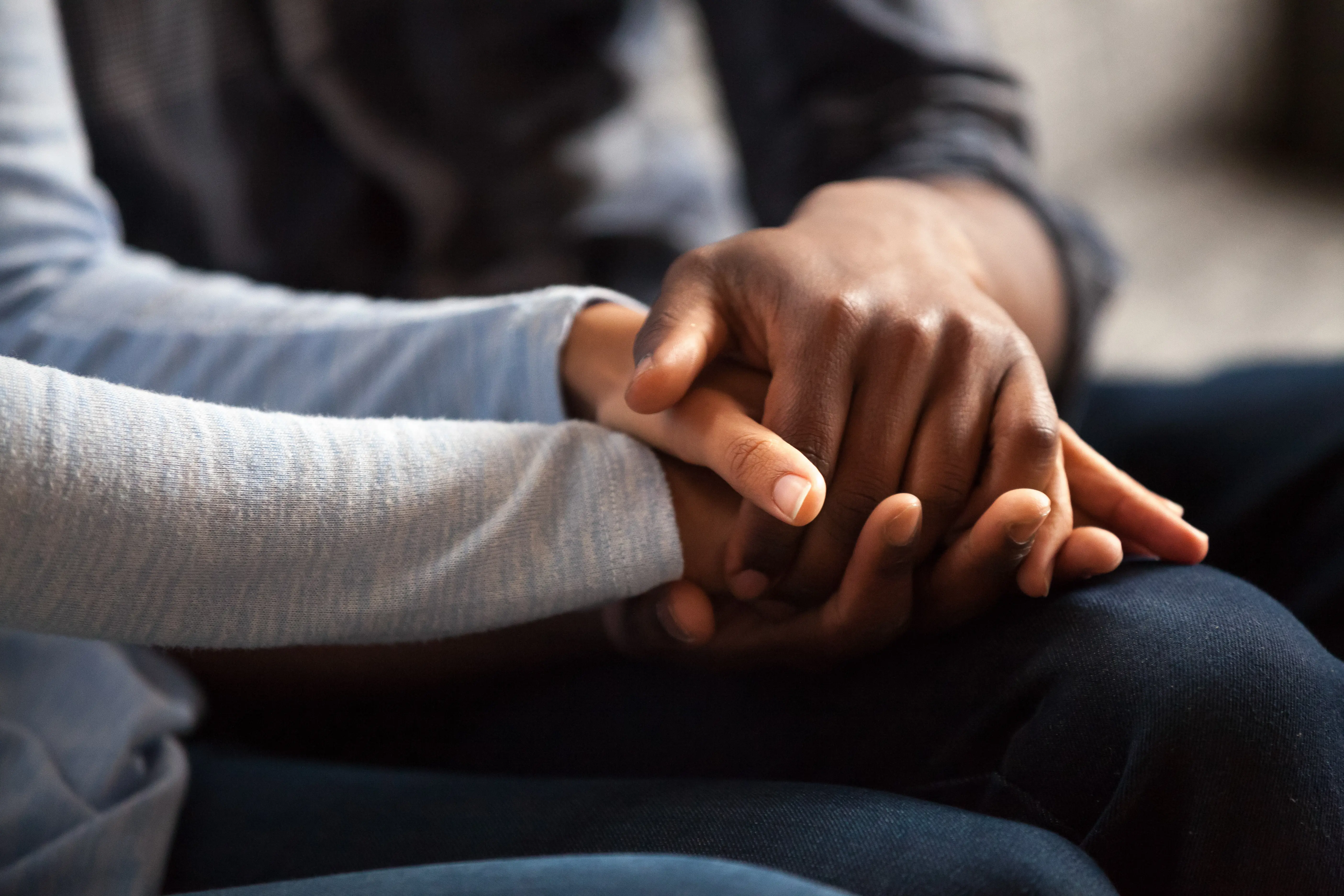 Two people holding hands