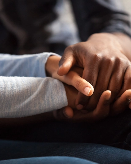 Two people holding hands