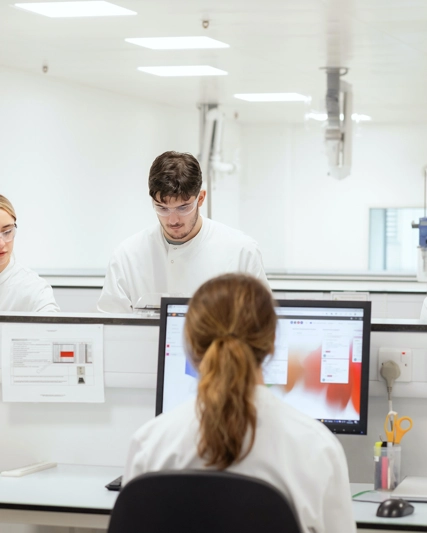 GSK quality lab team discussion around screens.