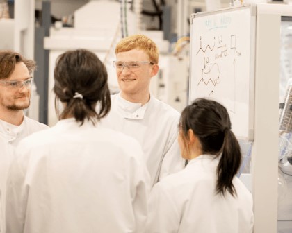 four scientists in a lab