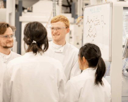 four scientists in a lab