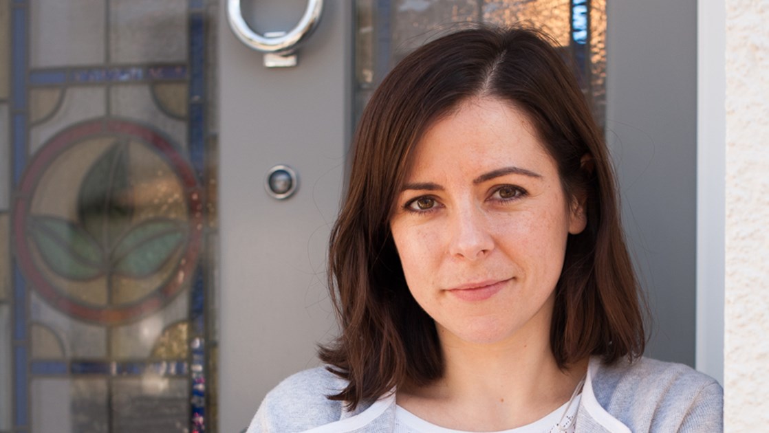 Jo, an R&D scientist leaning against a wall.