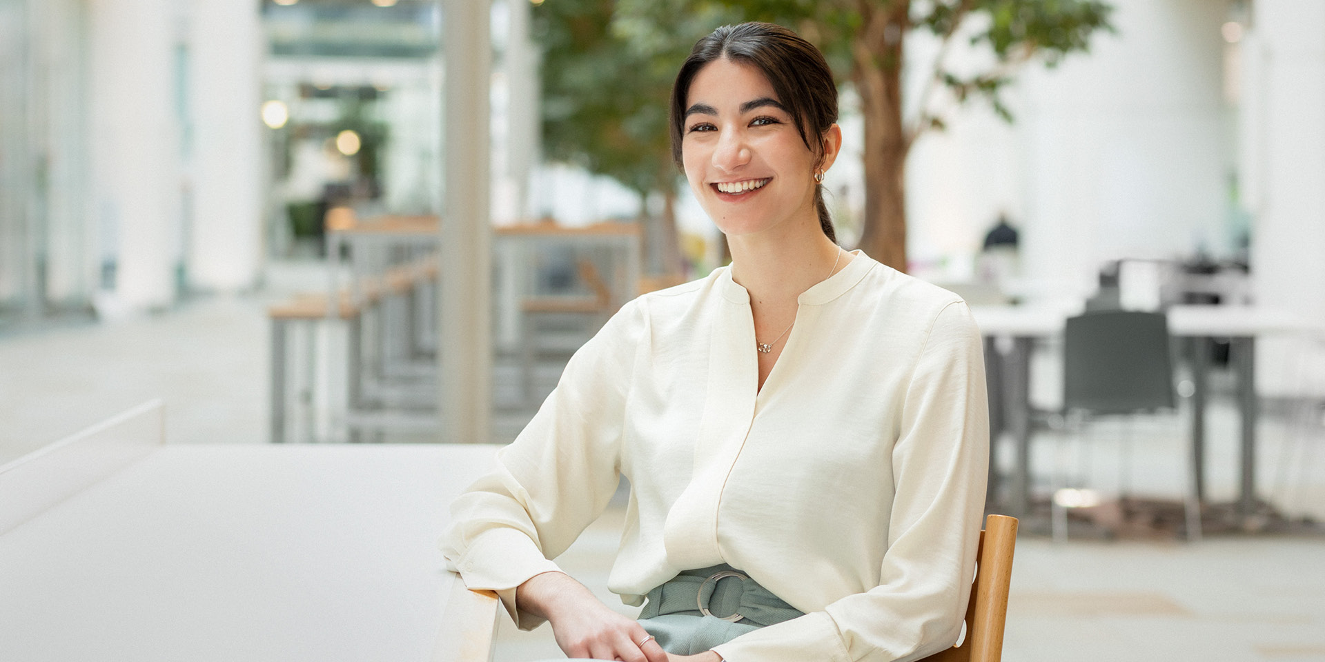 Woman sitting at a table and smiling