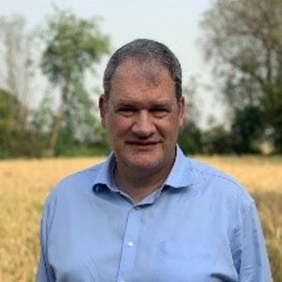 Man in shirt standing in field