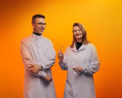 Two scientists on an orange background