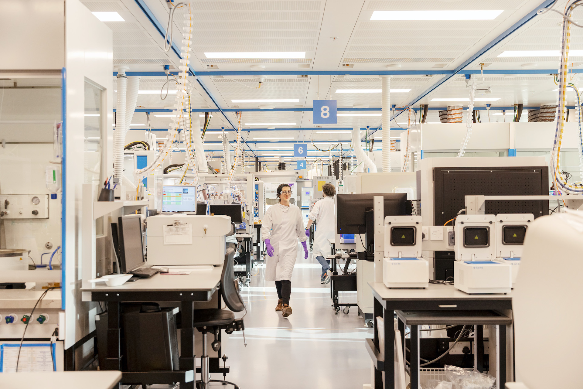 R&D scientist walking through chemistry smart lab.