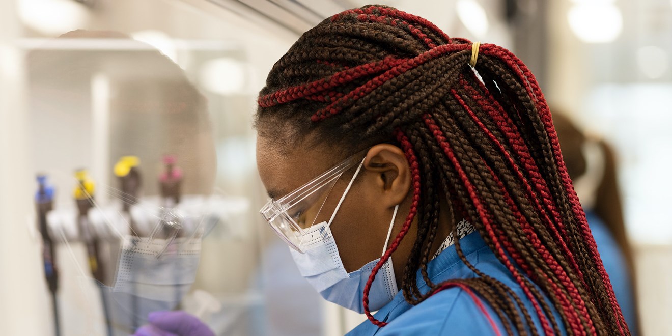 R&D formulation scientist working in cell and gene therapy, using a syringe.