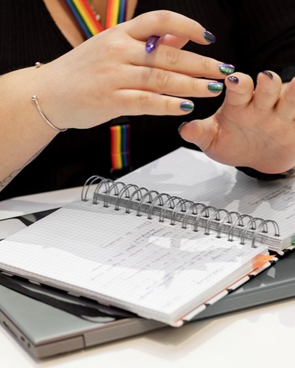 Woman holding a pencil and notepad