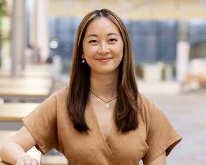 Woman smiling in a large modern office