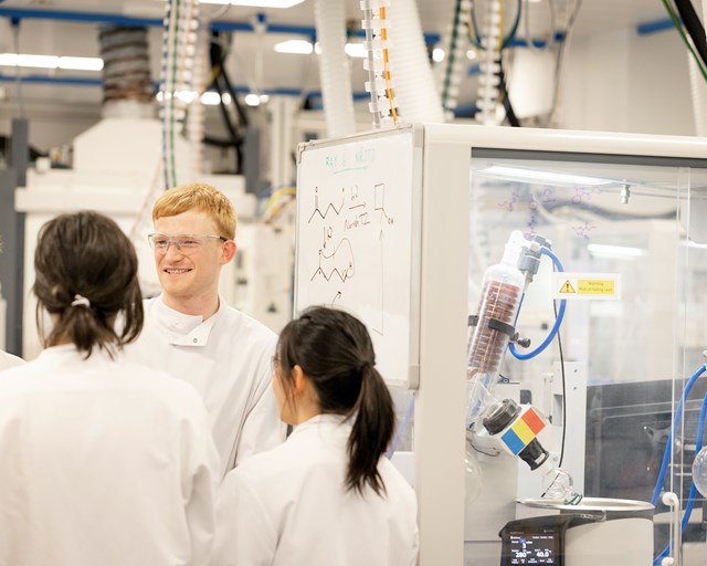 Scientists conversing over skeletal formulae