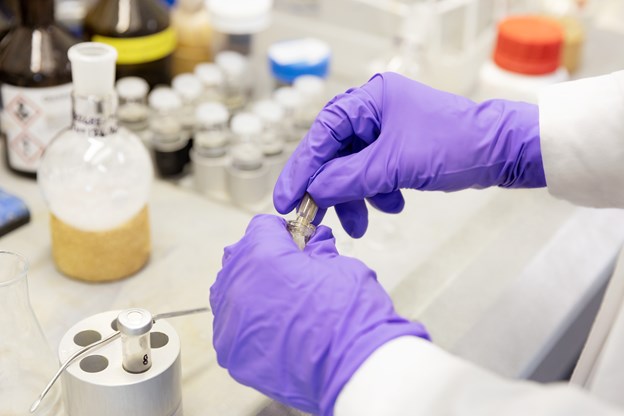 Scientist in the lab with globes on