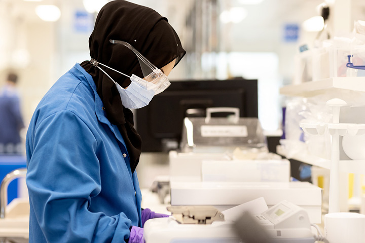 Scientist inspecting paperwork in lab 