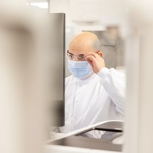 Lab worker adjusting glasses
