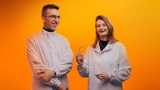 Two scientists on orange background