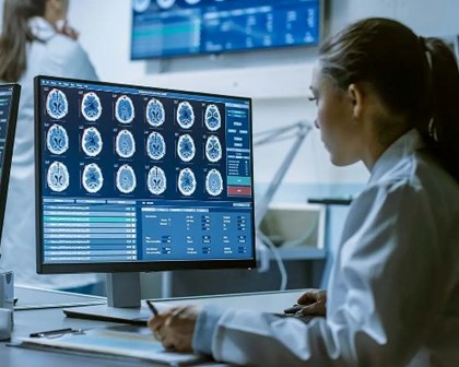 Woman studying scans on a computer