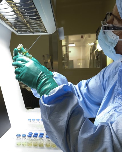 annual report 2022 pdf Scientist in a vaccine manufacturing lab