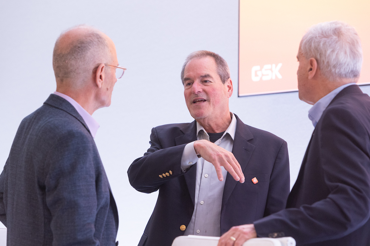 GSK Board Director, chair of science committee, Hal Barron speaks to two other committee members