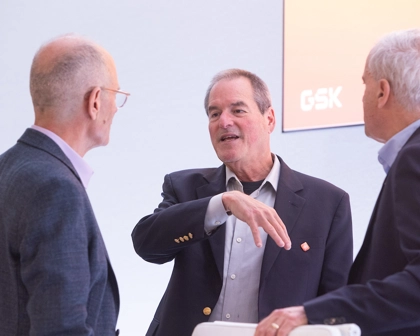 GSK Board Director, chair of science committee, Hal Barron speaks to two other committee members