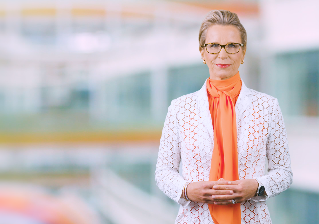 GSK CEO Emma Walmsley in orange shirt and white jacket