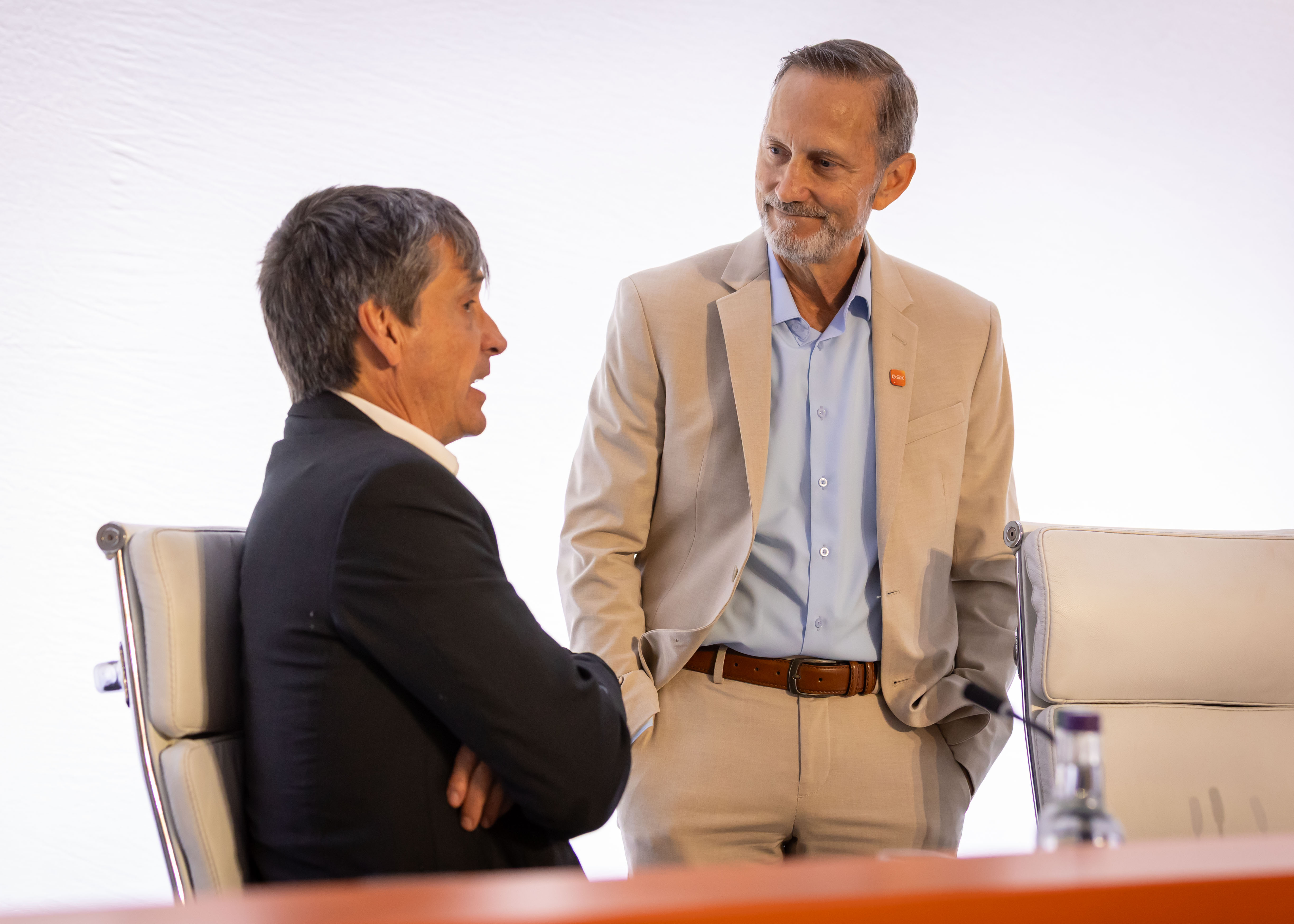 GSK Board member Dr Gavin Screaton speaks while Charles Bancroft listens