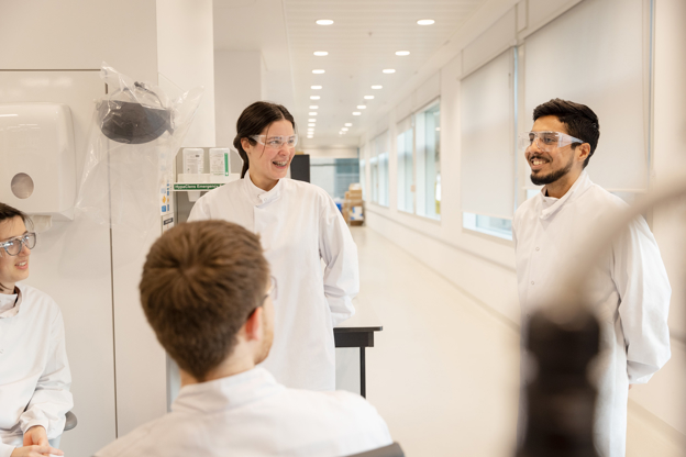 Scientists talking and laughing in a lab