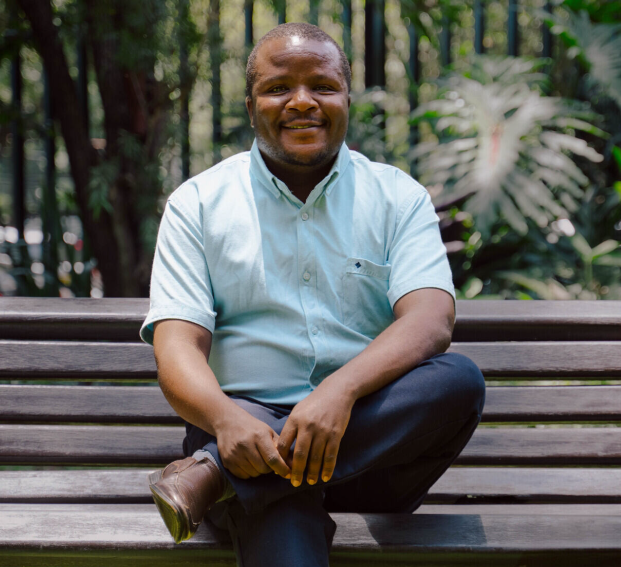 man sitting on bench and posing