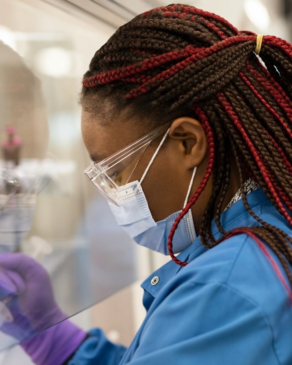 Scientist inspecting vial