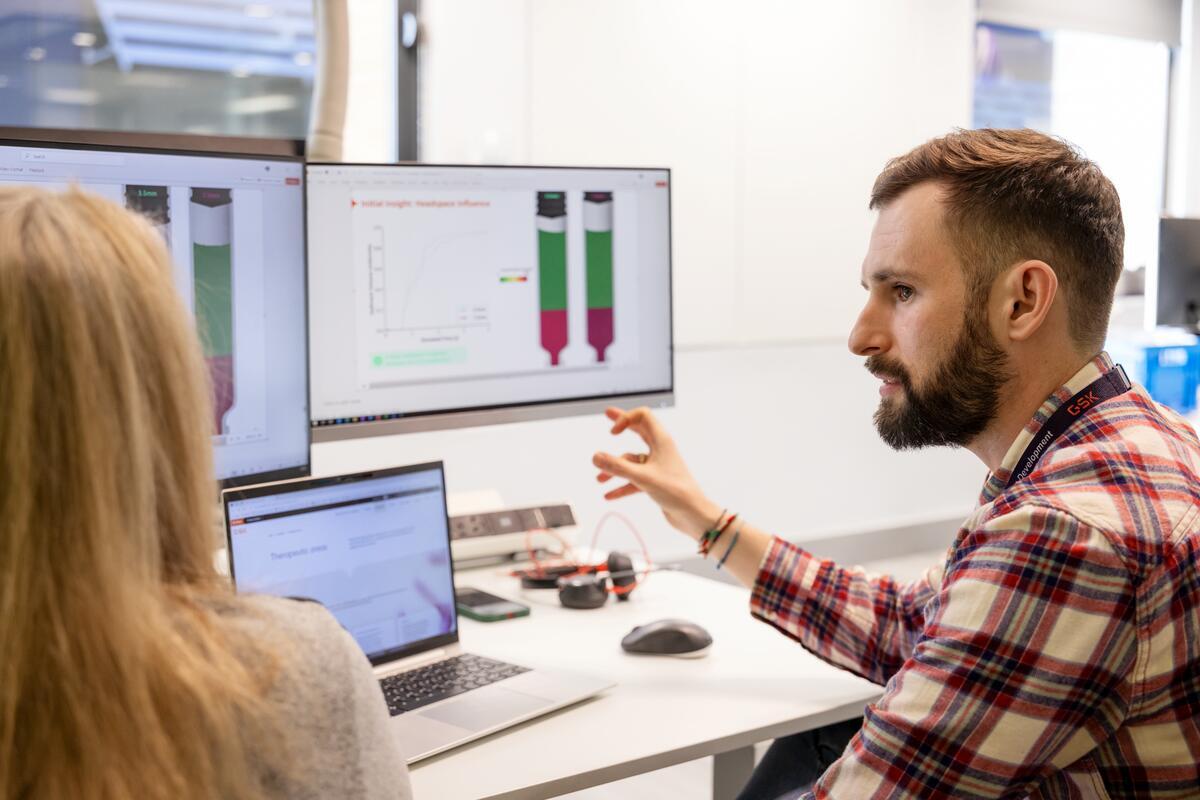 two device engineers collaborating at a screen
