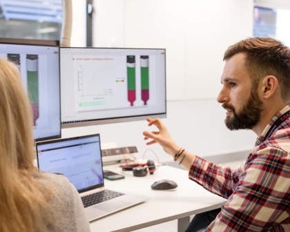 two device engineers collaborating at a screen