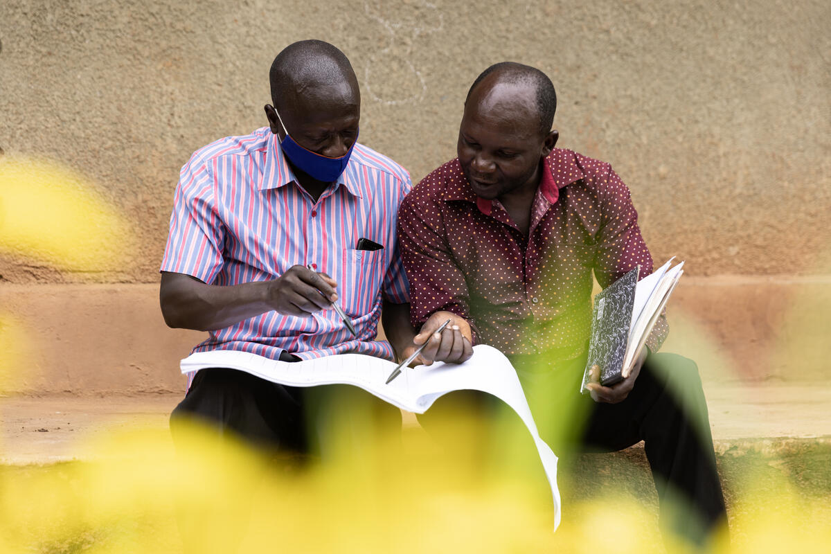 A member of the Volunteer Health Team meets with a caregiver