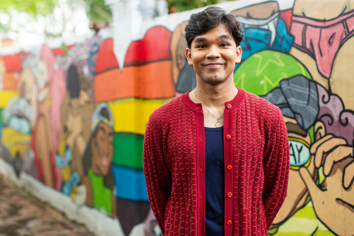 Portrait of a man in front of a graffiti wall