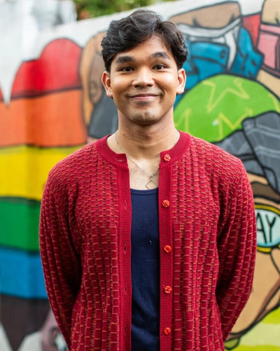 Portrait of a man in front of a graffiti wall