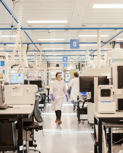 R&D scientist walking through chemistry smart lab.