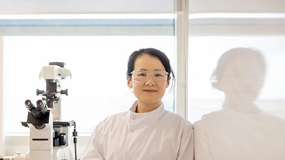 Lab technician leaning against wall