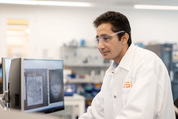 scientist working on mass spectrometer