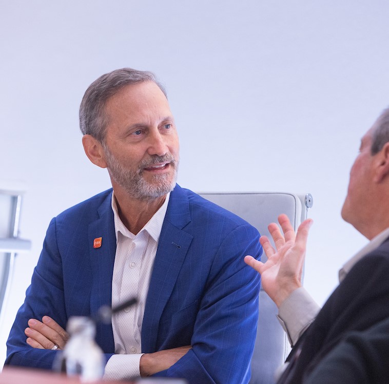 GSK Senior Independent Director, Charles Bancroft, listens as man sitting next to him speaks