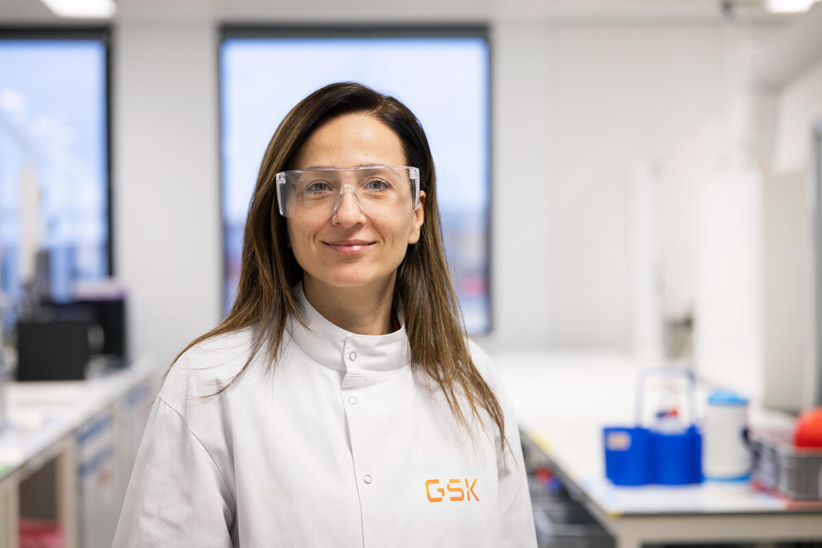 Lab scientist wearing safety glasses looking at camera