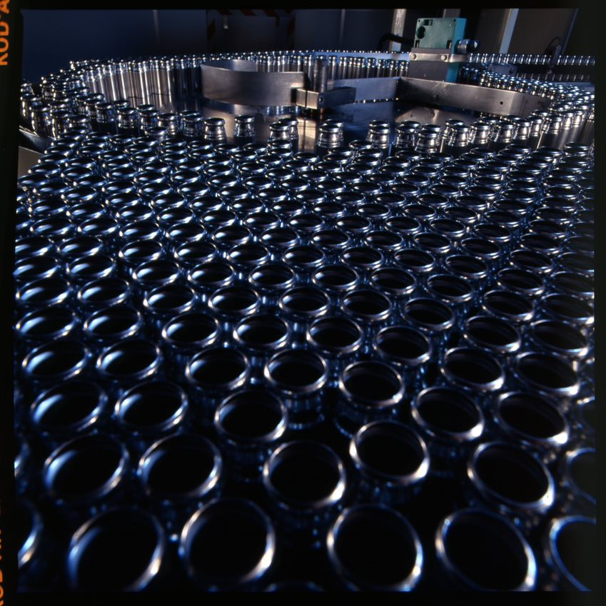 Empty inhaler canisters entering the filling machine, 1980s